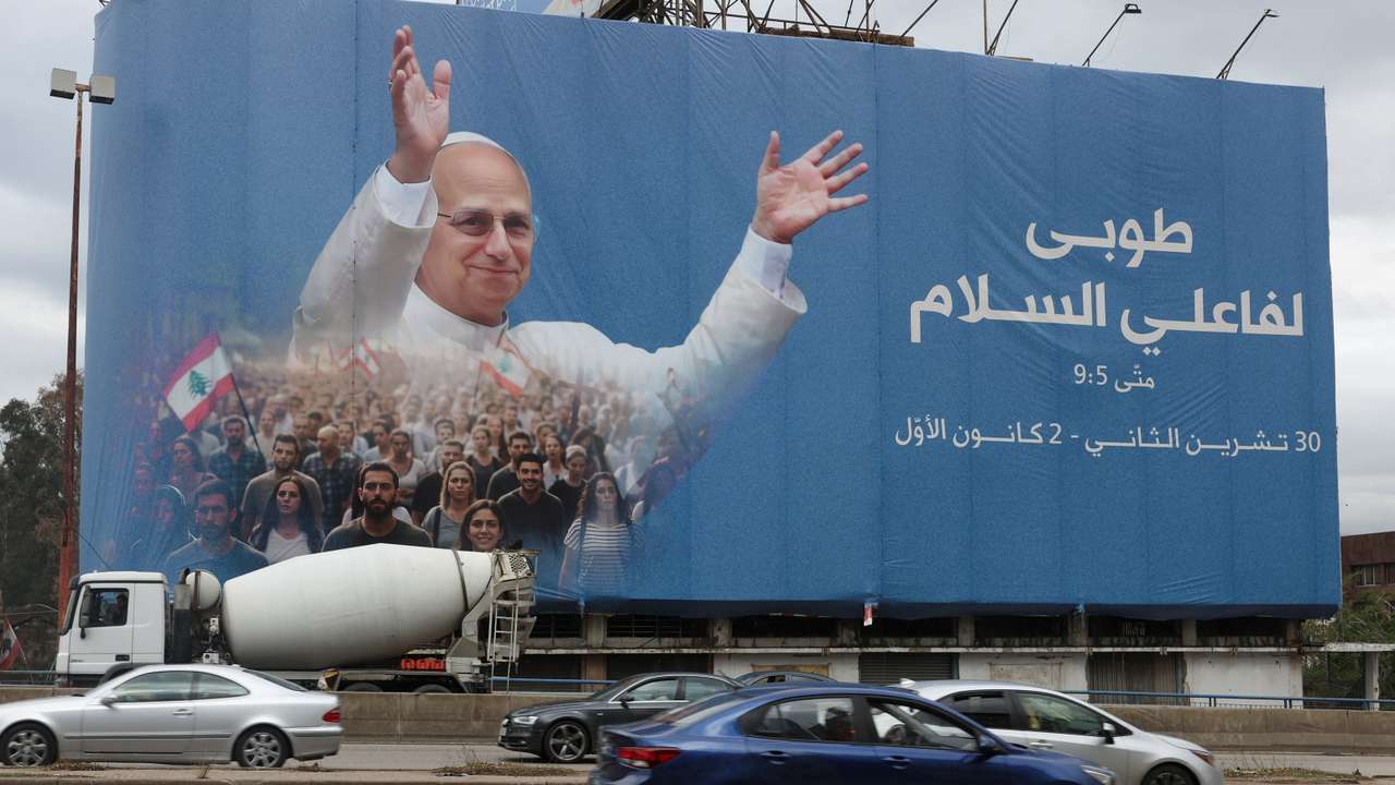 Cars drive past a billboard depicting Pope Leo XIV, ahead of his planned visit to Lebanon, in Beirut