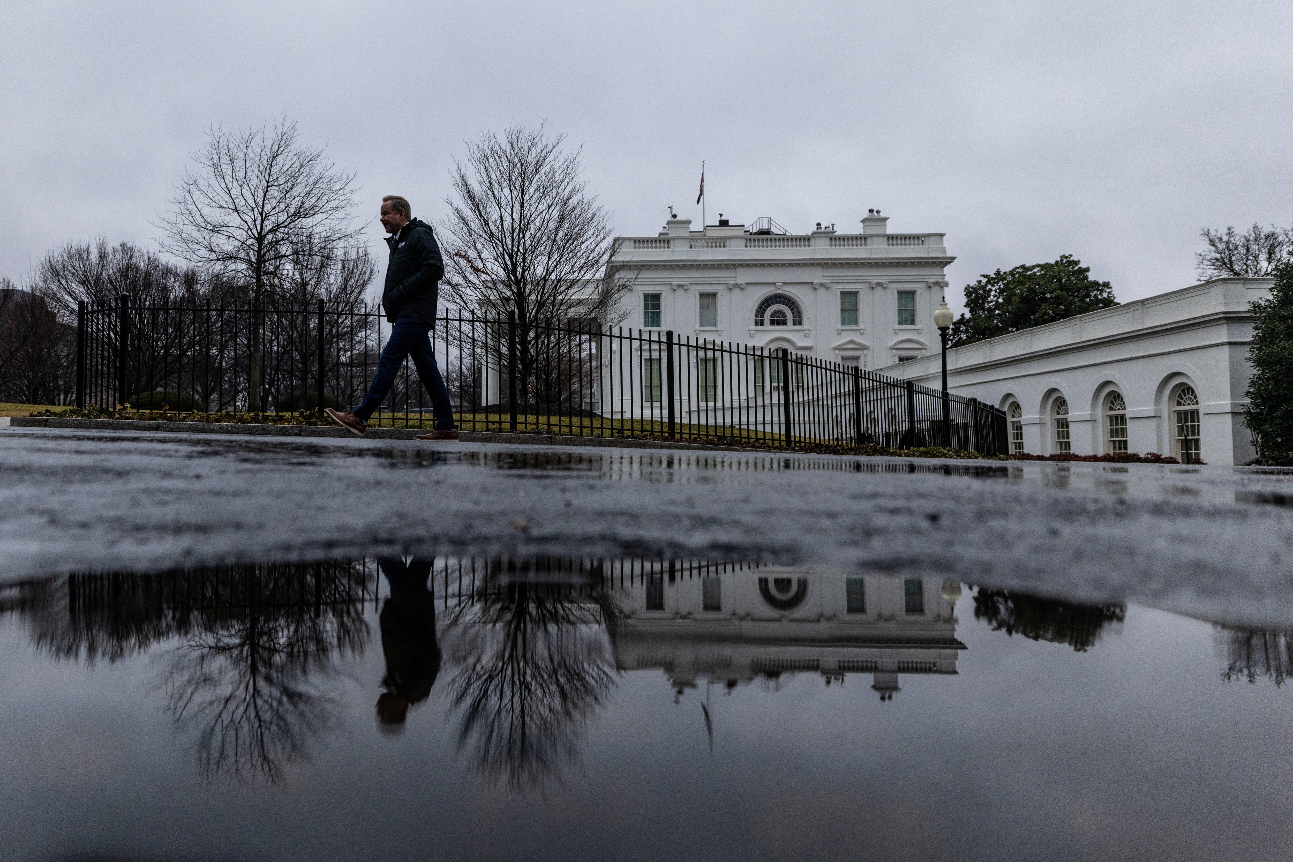A reporter leaves the White House after the daily briefing in Washington
