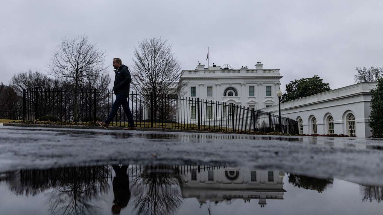 A reporter leaves the White House after the daily briefing in Washington