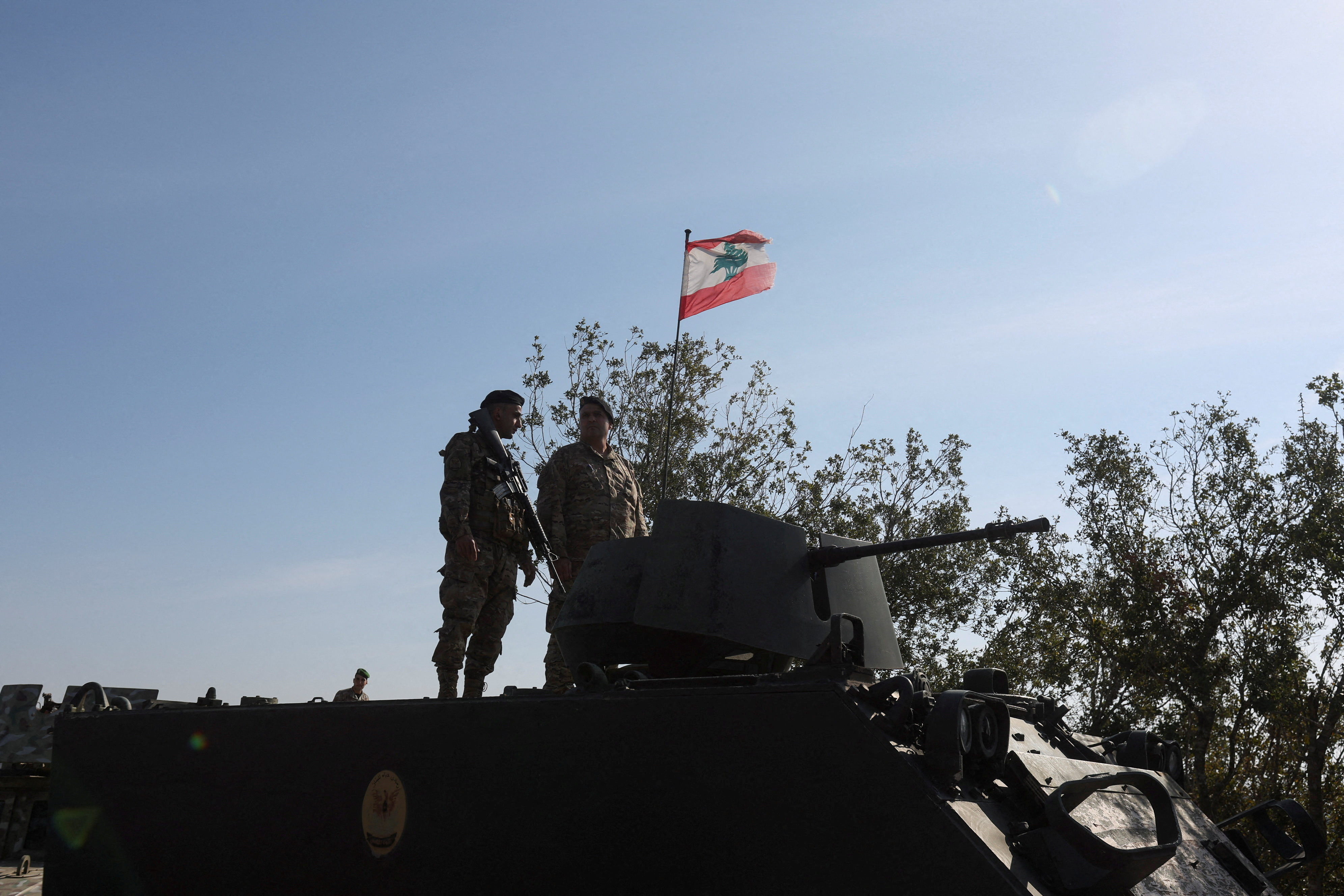 FILE PHOTO: Lebanese army members stand on a military vehicle during a Lebanese army media tour, to review the army's operations in the southern Litani sector, in Alma Al-Shaab
