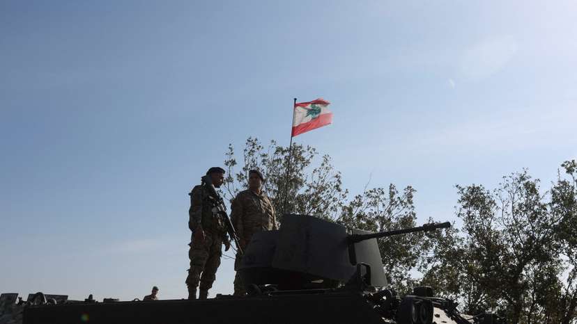 FILE PHOTO: Lebanese army members stand on a military vehicle during a Lebanese army media tour, to review the army's operations in the southern Litani sector, in Alma Al-Shaab
