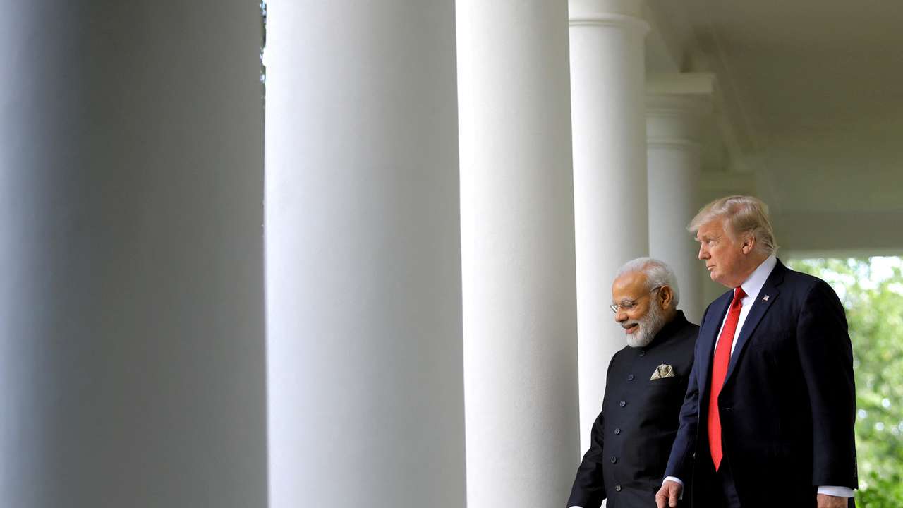 FILE PHOTO: U.S. President Donald Trump (R) arrives for a joint news conference with Indian Prime Minister Narendra Modi (L) in the Rose Garden of the White House in Washington, U.S.