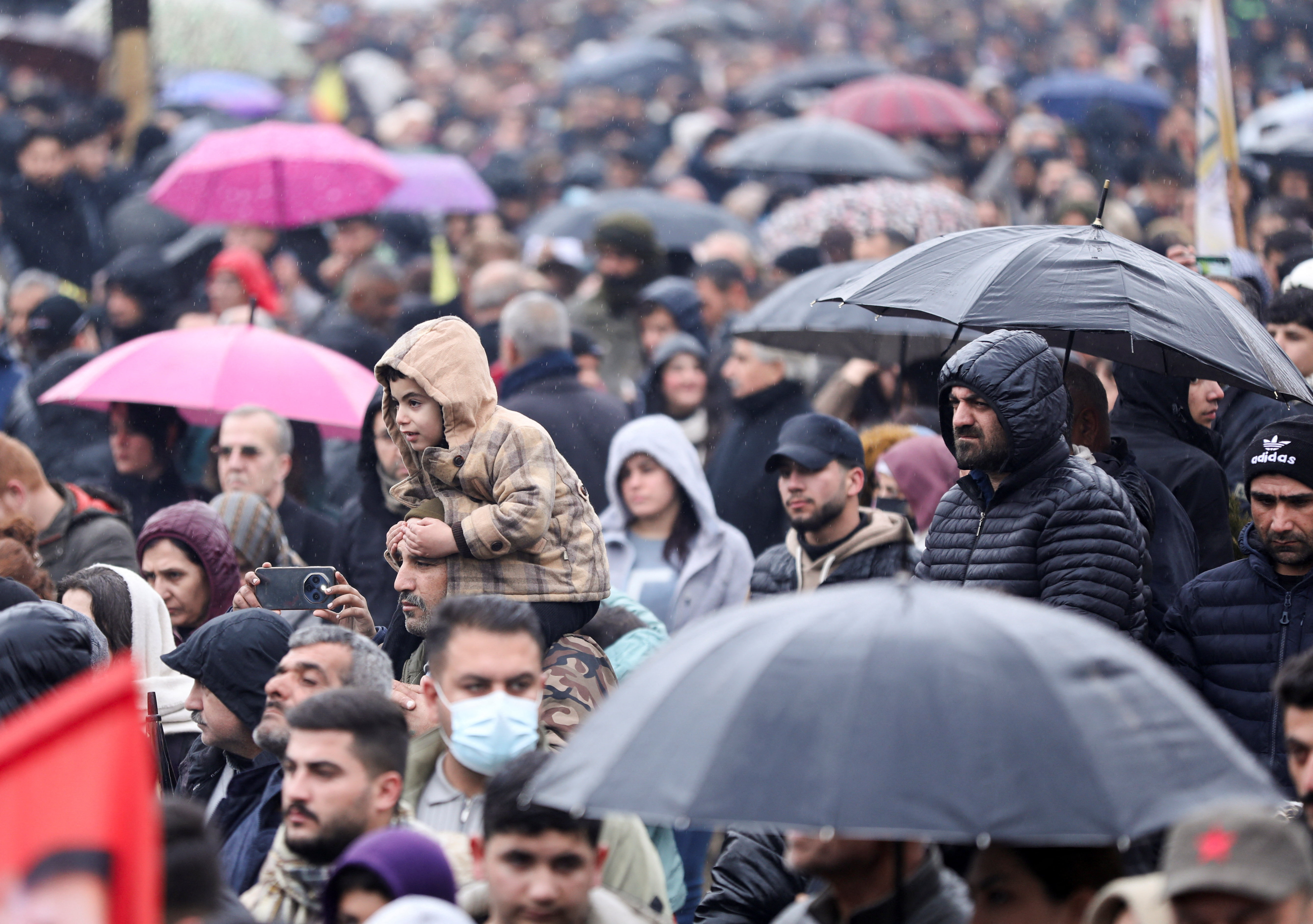 Syrian Kurds attend a protest in solidarity with the people in the neighborhood of Sheikh Maksoud and Ashrafiya, in Qamishli