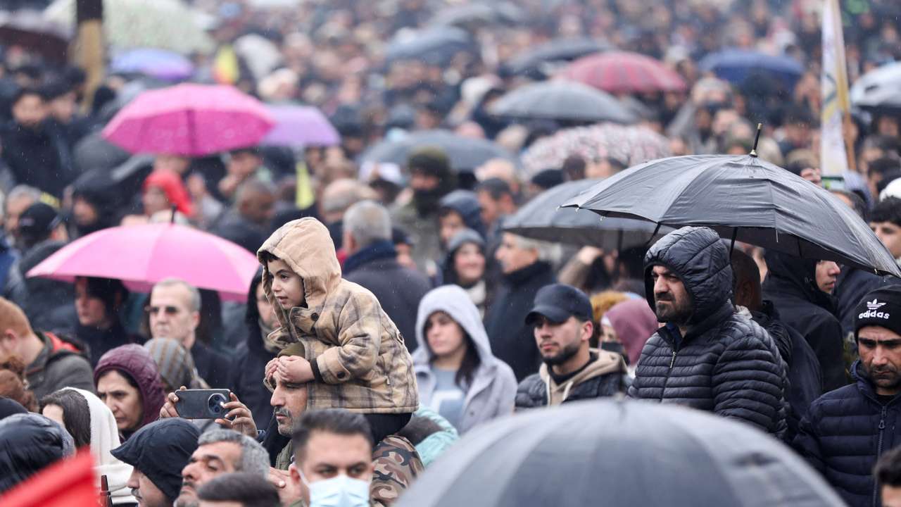 Syrian Kurds attend a protest in solidarity with the people in the neighborhood of Sheikh Maksoud and Ashrafiya, in Qamishli
