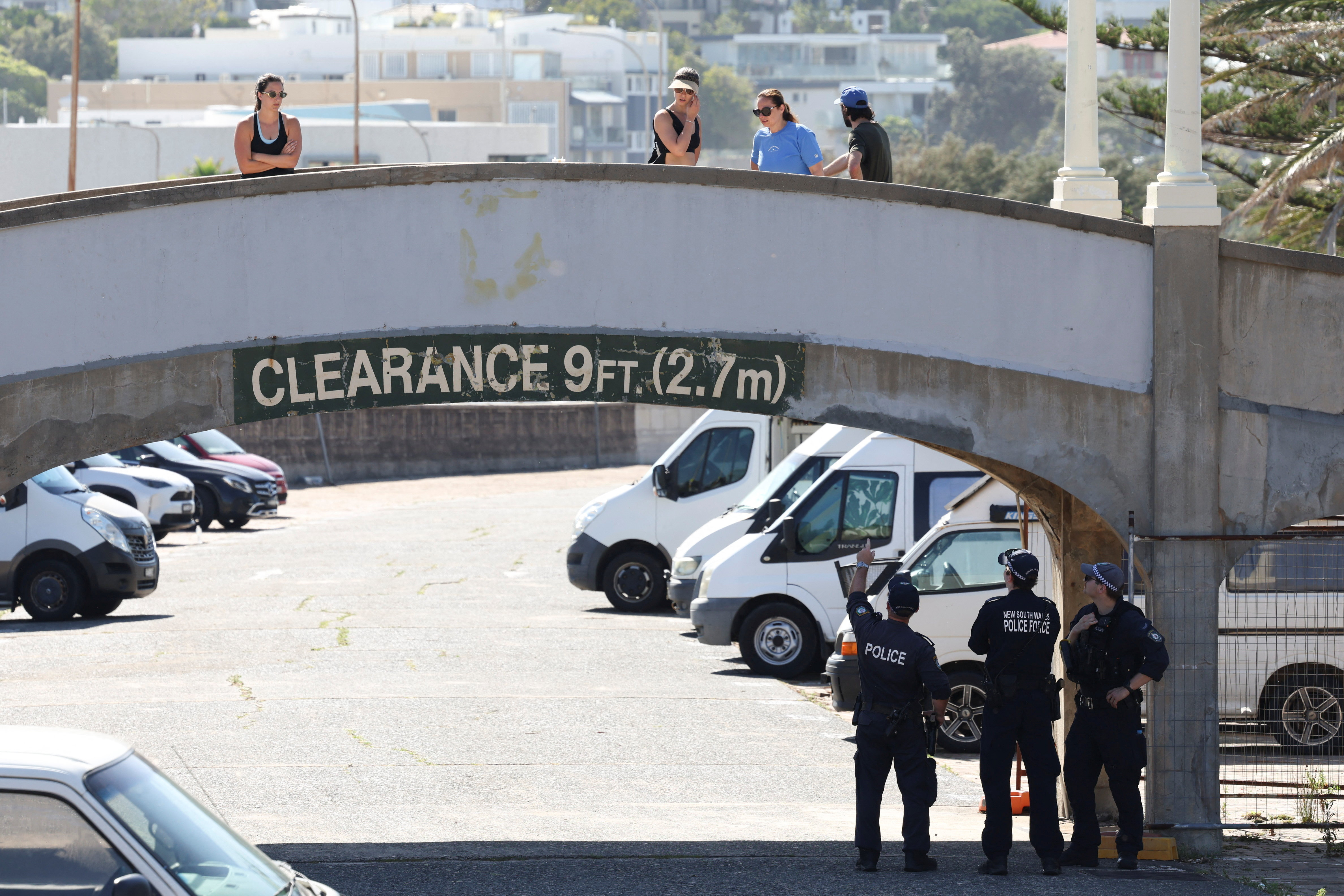 People visit the crime scene after it was reopened following the mass shooting at Bondi Beach