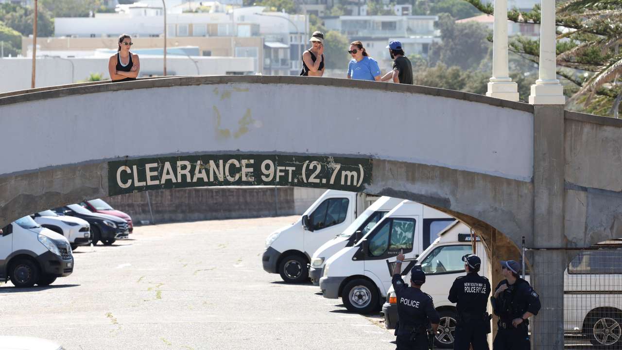 People visit the crime scene after it was reopened following the mass shooting at Bondi Beach