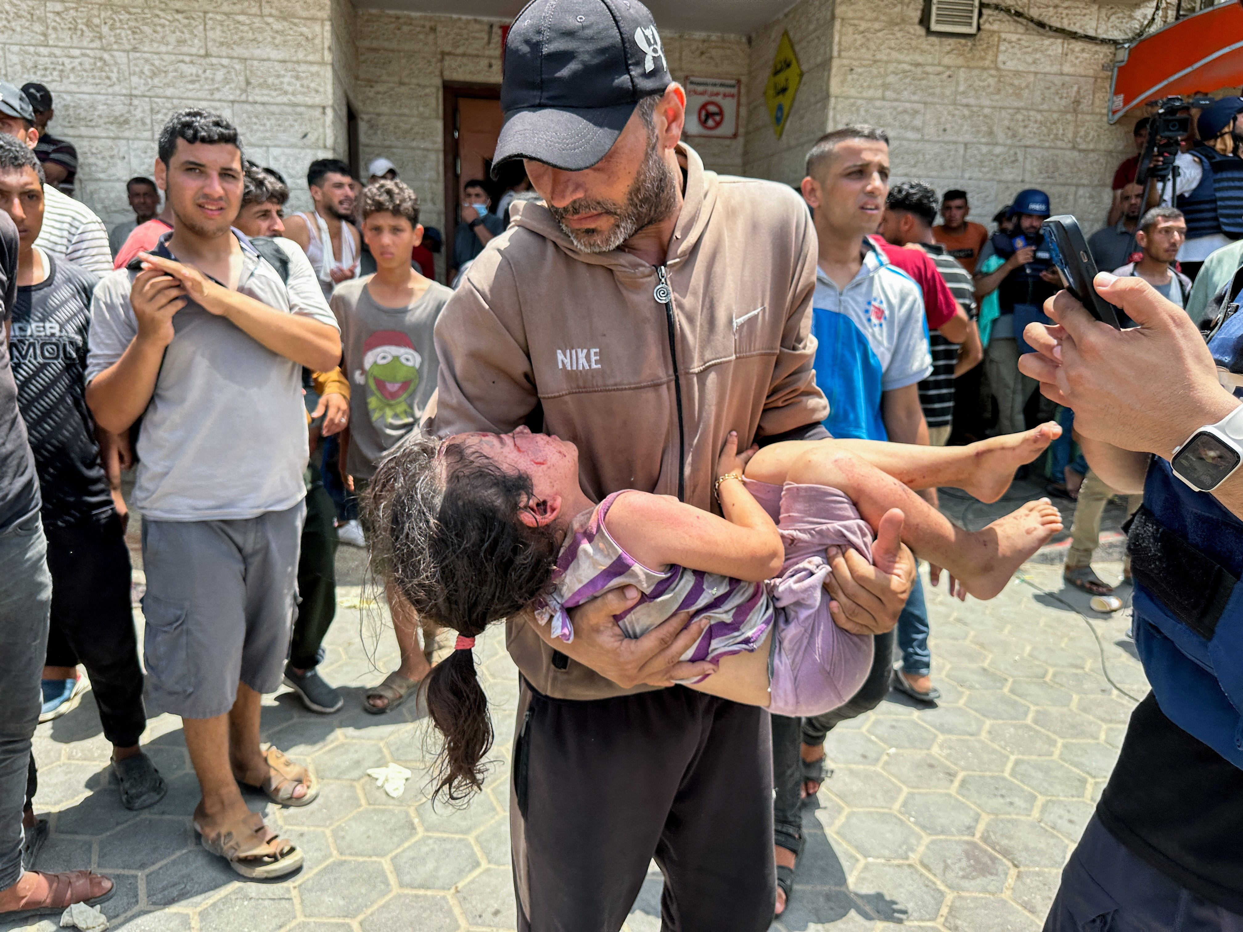 Palestinians wounded in an Israeli strike are brought to Al-Aqsa Martyrs Hospital, in Deir Al-Balah