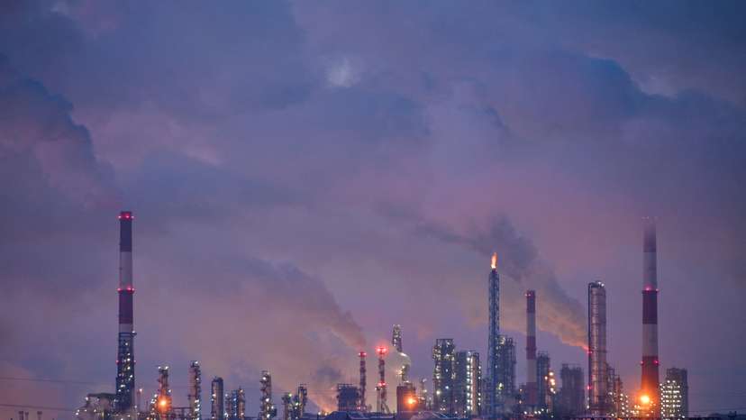 Flue gas and steam rise out of chimneys of an oil refinery in Omsk
