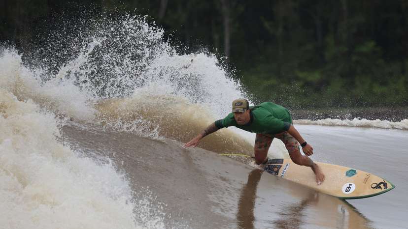 Brazilian surfer Sergio Laus rides the thunderous pororoca tidal bore wave on the Mearim River, in the Amazon jungle