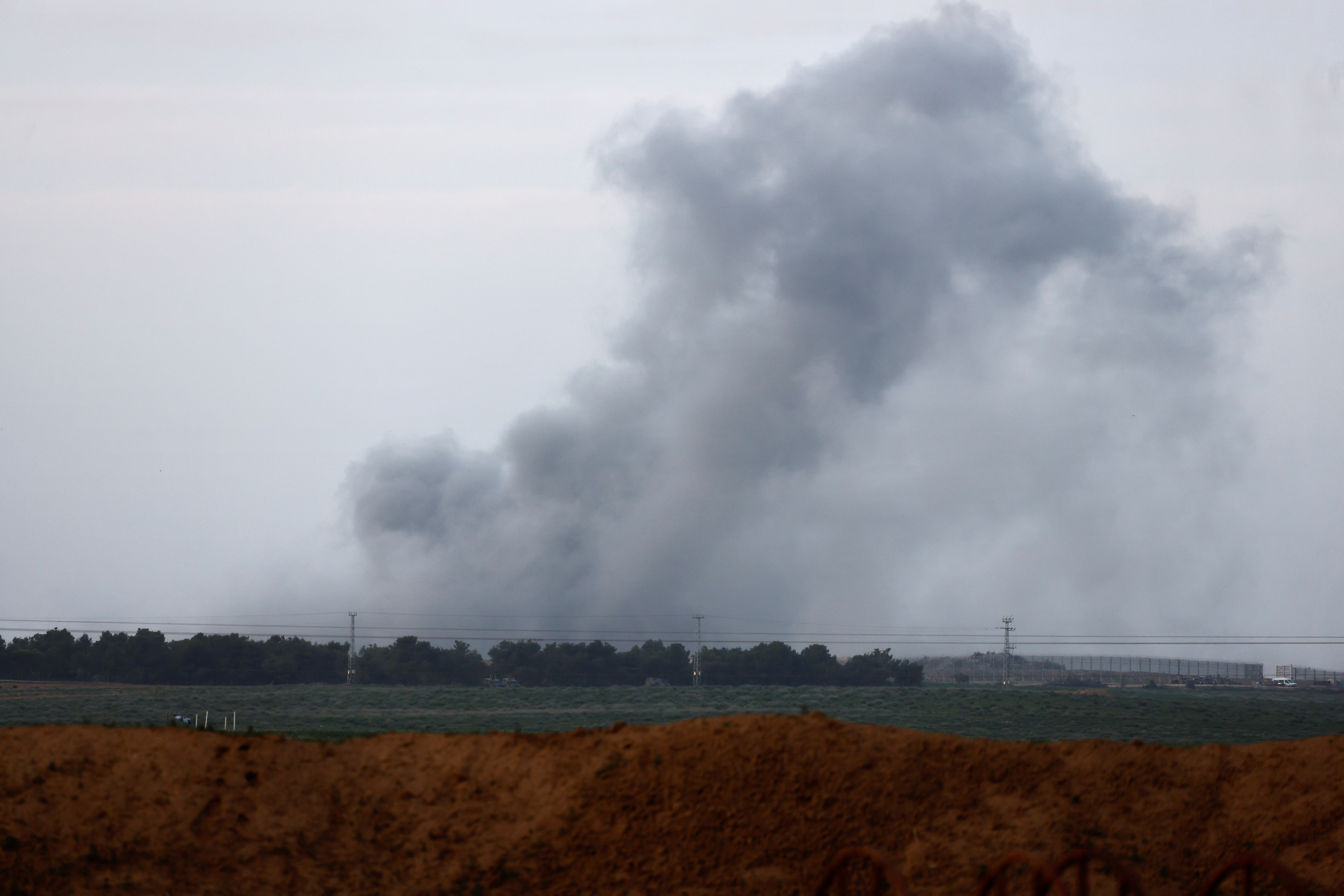 Smoke rises above the Gaza Strip as seen from Israel's border with Gaza