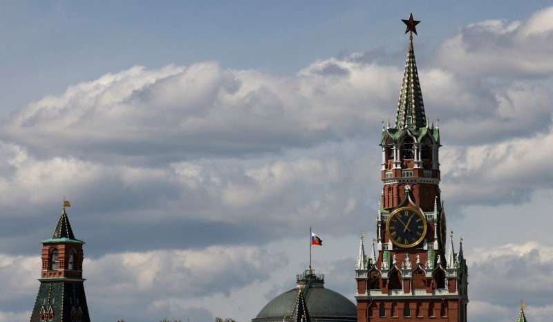 The Russian flag flies on the dome of the Kremlin Senate building in Moscow