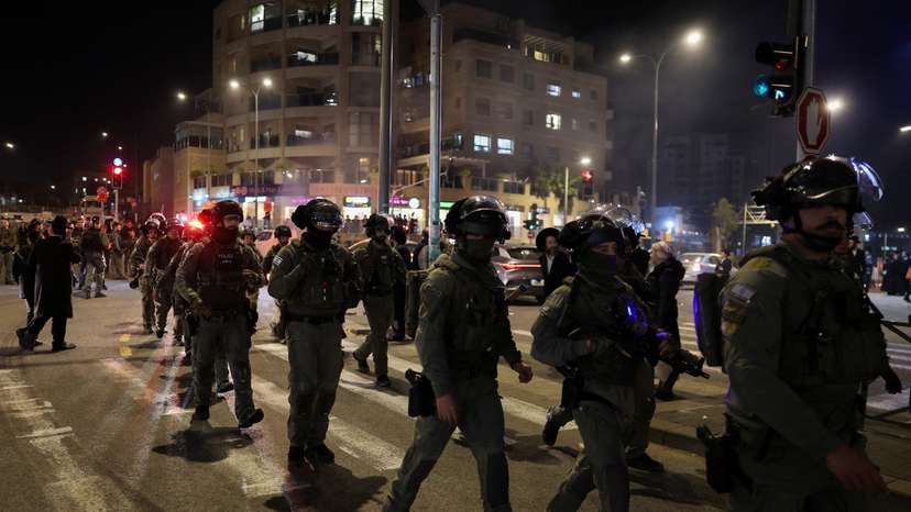 Israeli security forces secure the area, after, according to Israel's ambulance service, a person was killed in a collision involving a bus and several pedestrians, in Jerusalem