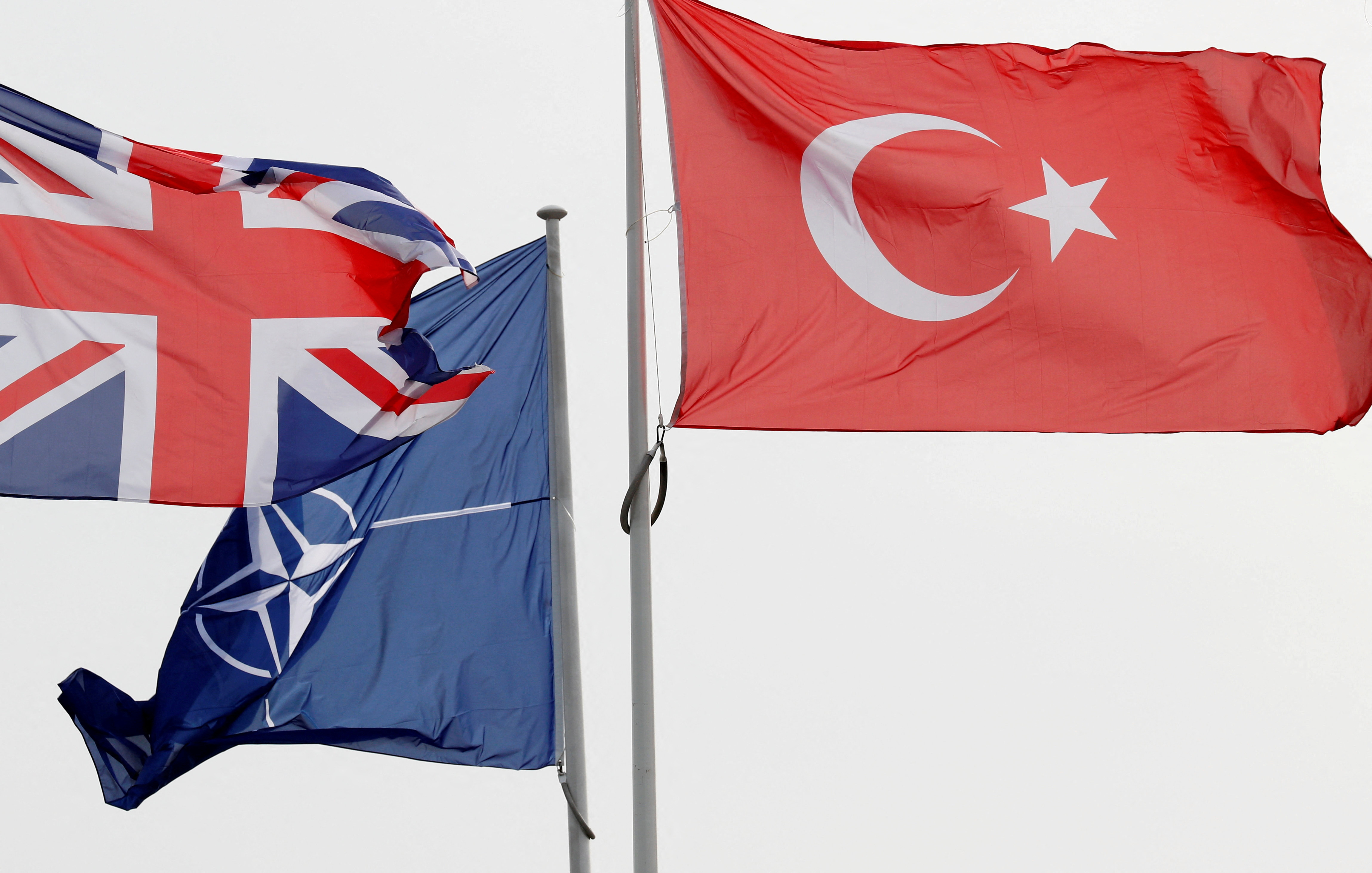 FILE PHOTO: NATO, British and Turkish flags flutter at the Alliance headquarters in Brussels