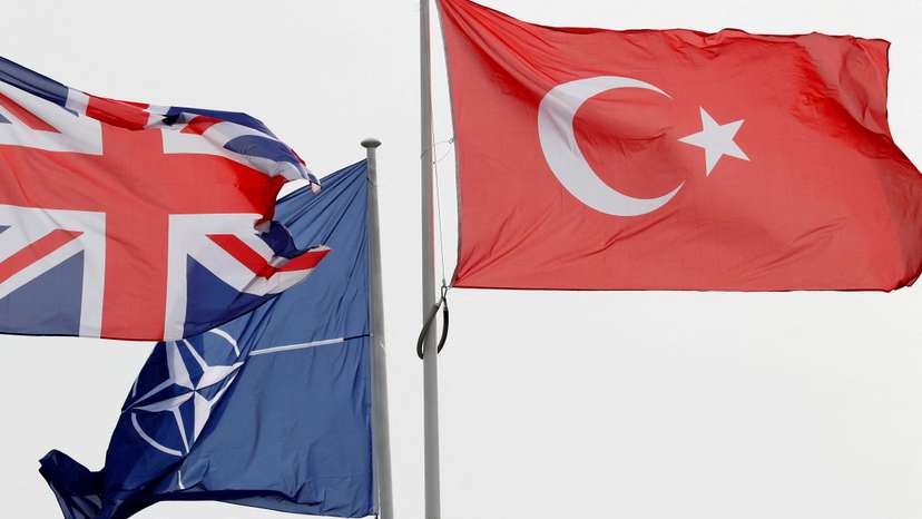 FILE PHOTO: NATO, British and Turkish flags flutter at the Alliance headquarters in Brussels
