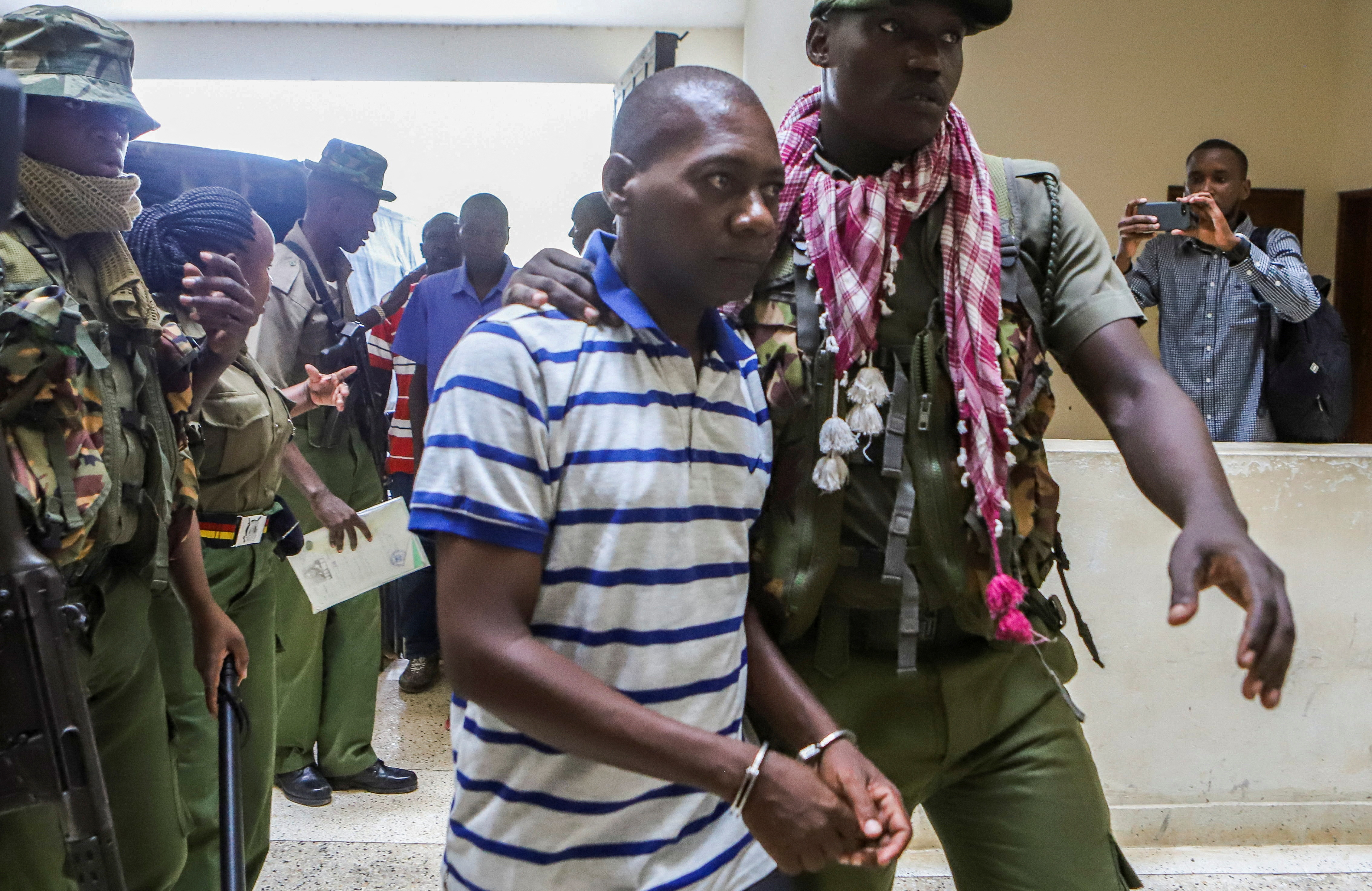Paul Mackenzie, a Kenyan cult leader accused of ordering his followers, who were members of the Good News International Church, to starve themselves to death in Shakahola forest, is escorted to the Malindi Law Courts