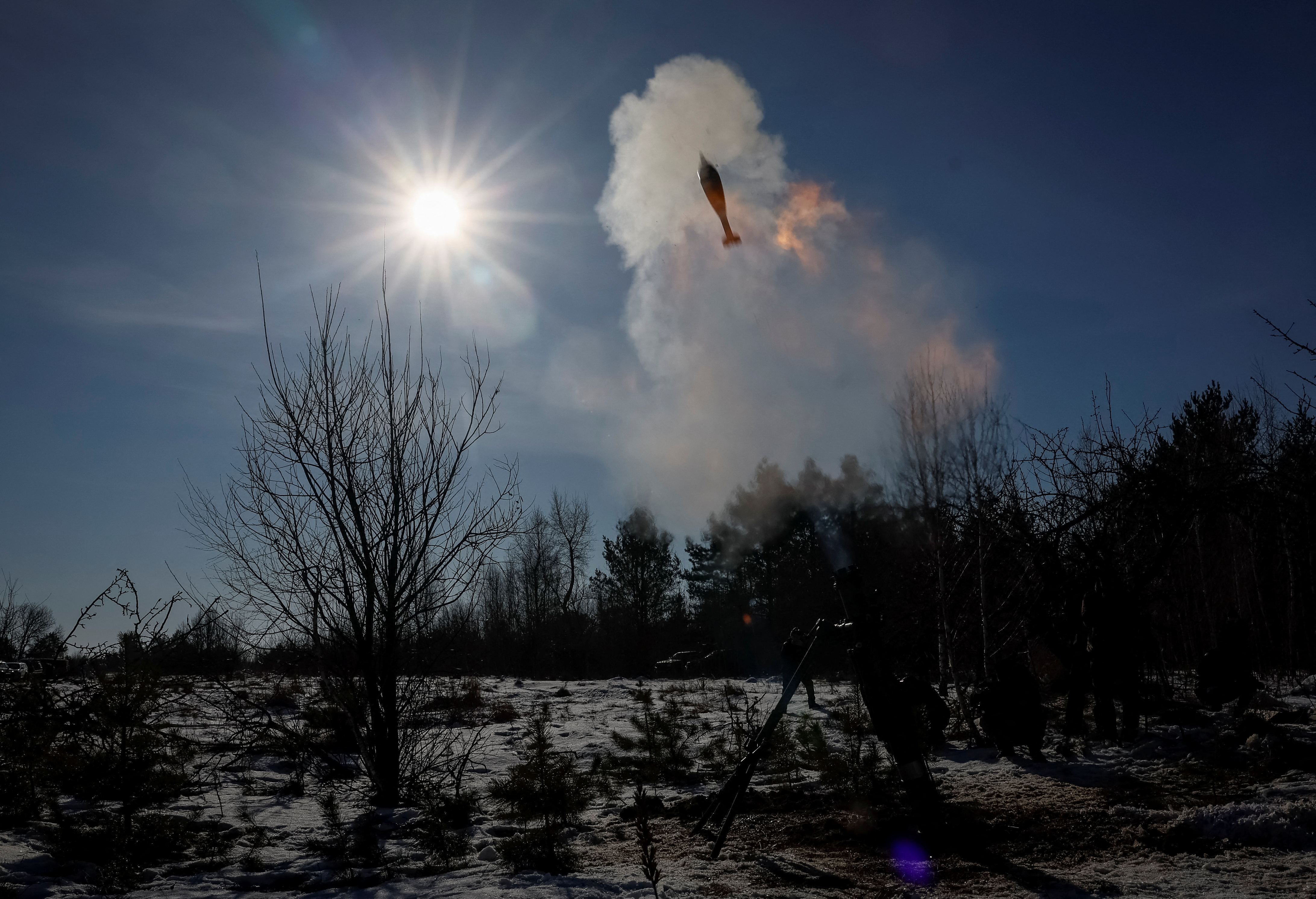 Ukrainian servicemen fire a 120-mm mortar during military exercises in Zhytomyr region