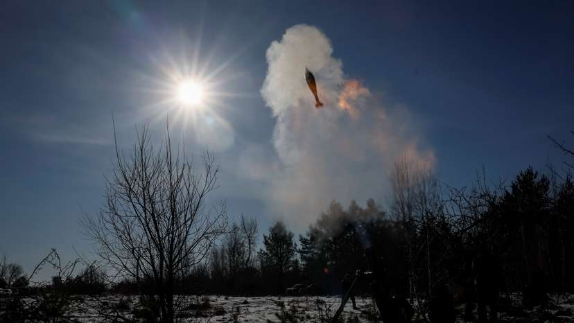 Ukrainian servicemen fire a 120-mm mortar during military exercises in Zhytomyr region