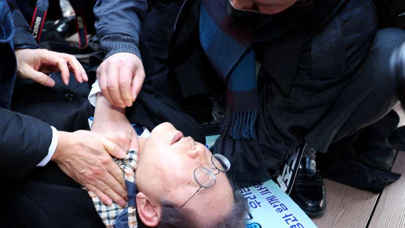 South Korea's opposition party leader Lee Jae-myung falls after being attacked by an unidentified man during his visit to Busan