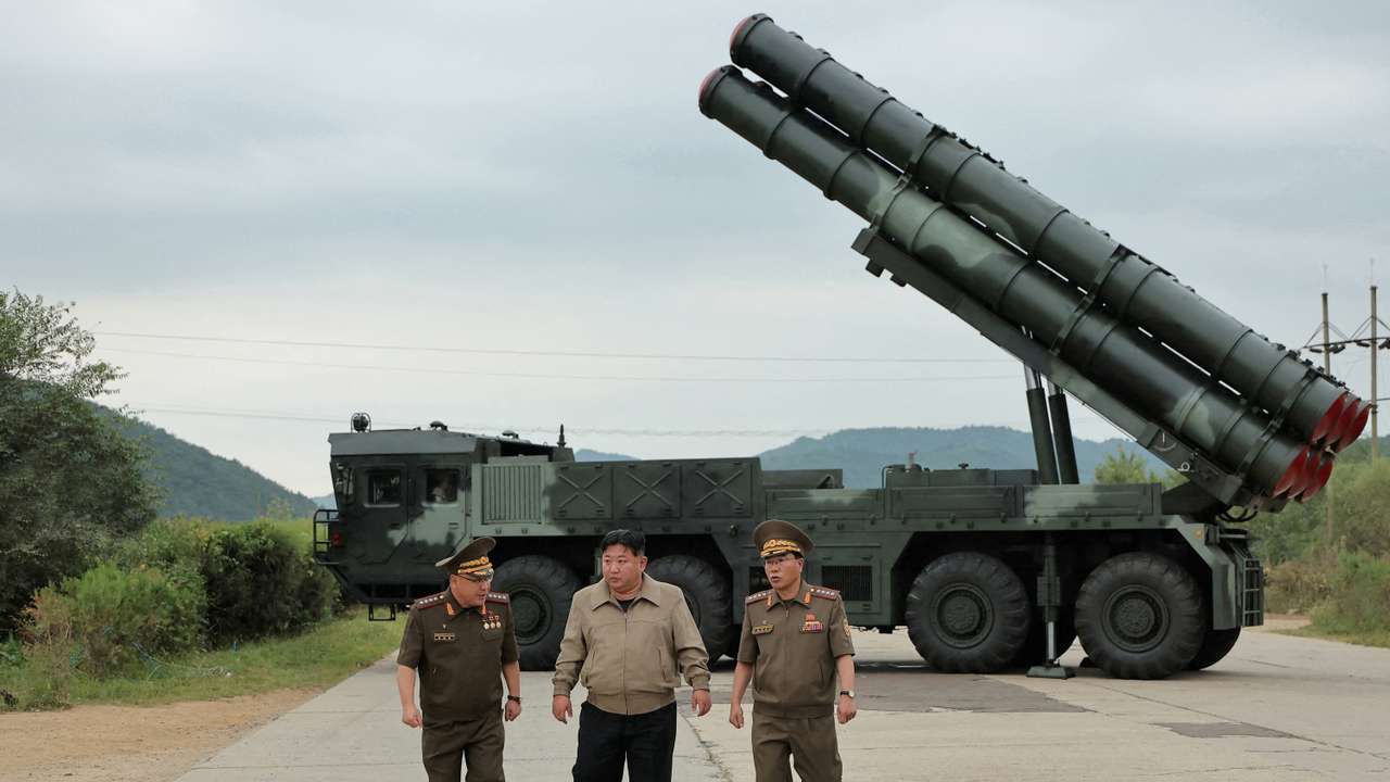North Korean leader Kim Jong Un oversees a test-fire for a new 600mm multiple rocket launcher