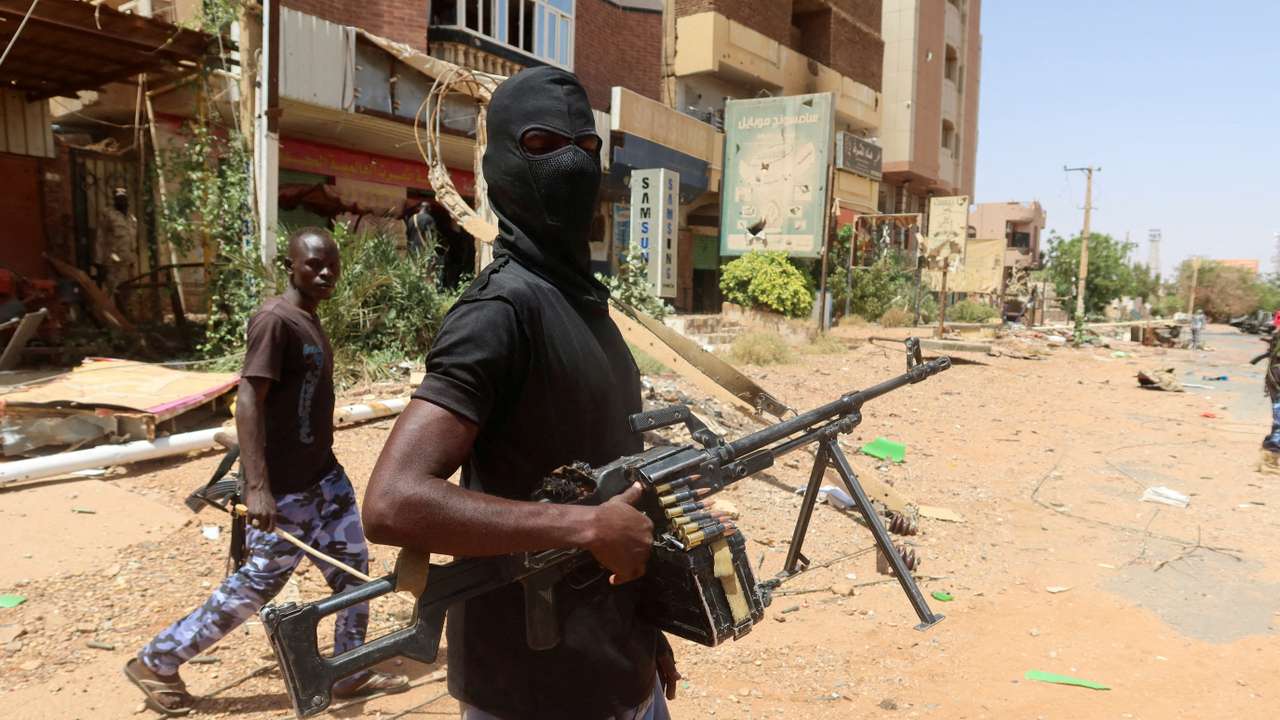FILE PHOTO: A member of Sudanese armed forces looks on as he holds his weapon in the street in Omdurman