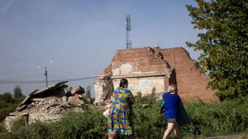 Women run for cover as rounds of shelling hit nearby in Selydove near Pokrovsk