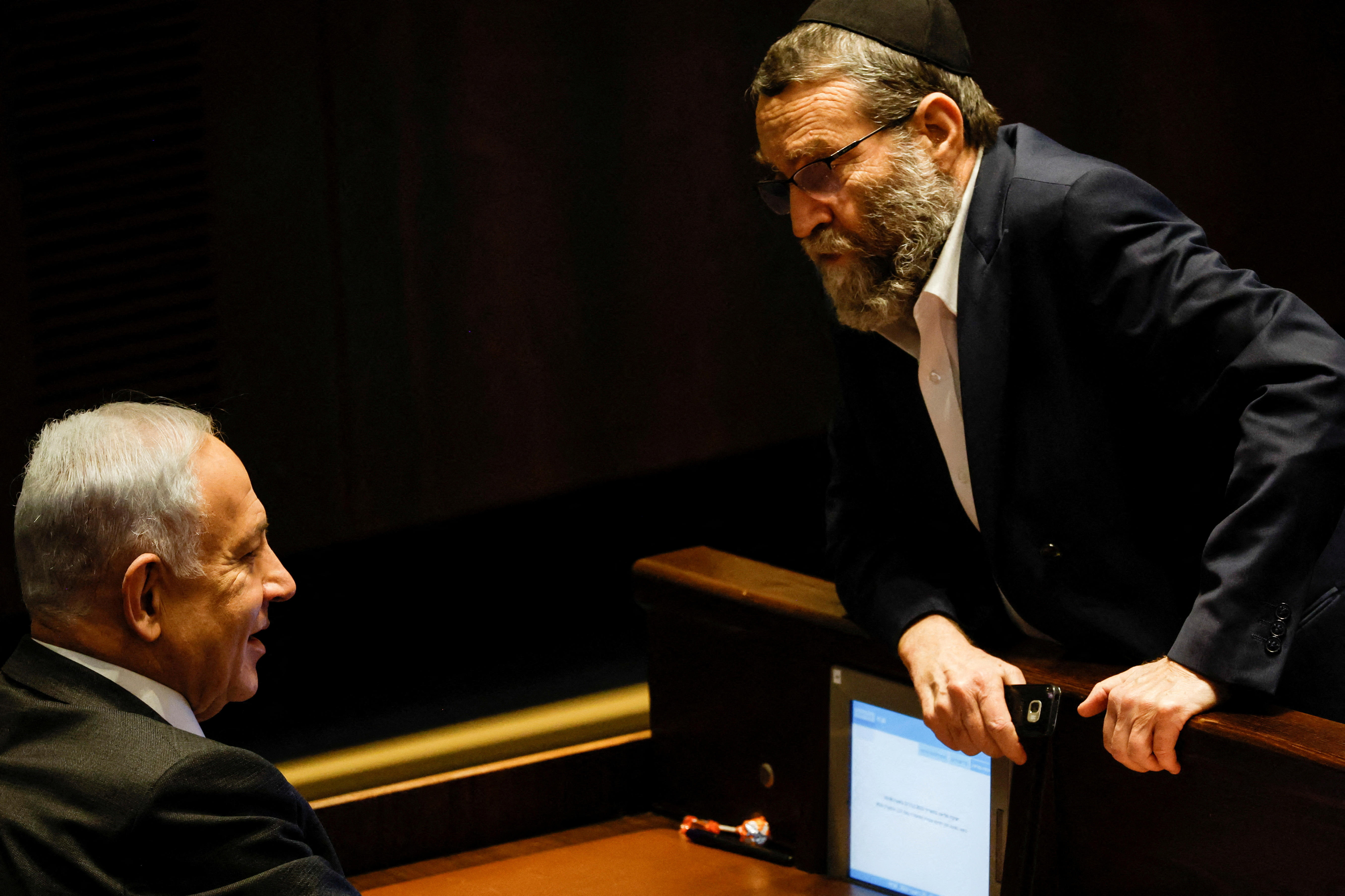 FILE PHOTO: Moshe Gafni, head of United Torah Judaism party, chats with Israeli designate Prime Minister Benjamin Netanyahu during a session at the plenum at the Knesset, Israel's parliament in Jerusalem