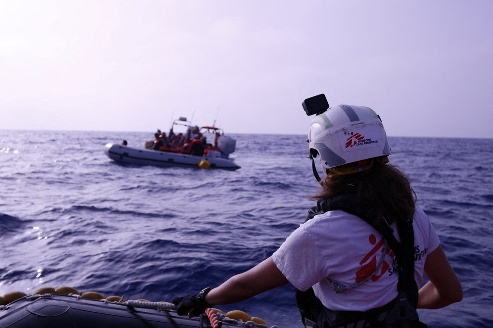 Handout image shows a Medecins Sans Frontieres (MSF) rescue boat near a rubber boat carrying migrants in the Mediterranean Sea