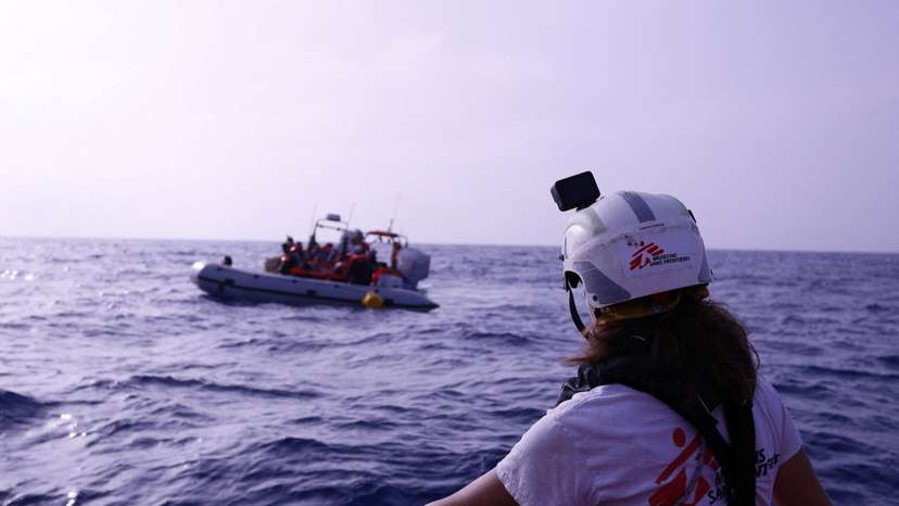 Handout image shows a Medecins Sans Frontieres (MSF) rescue boat near a rubber boat carrying migrants in the Mediterranean Sea