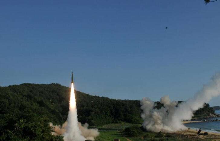 FILE PHOTO: Handout of United States and South Korean troops utilizing the Army Tactical Missile System (ATACMS) and South Korea's Hyunmoo Missile II, fire missiles into the waters of the East Sea, off South Korea