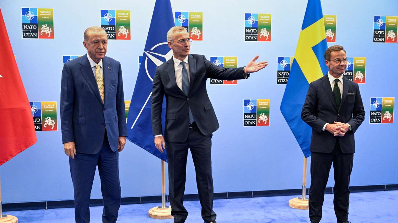 FILE PHOTO: Turkish President Erdogan and Swedish Prime Minister Kristersson shake hands next to NATO Secretary-General Stoltenberg prior to their meeting, in Vilnius