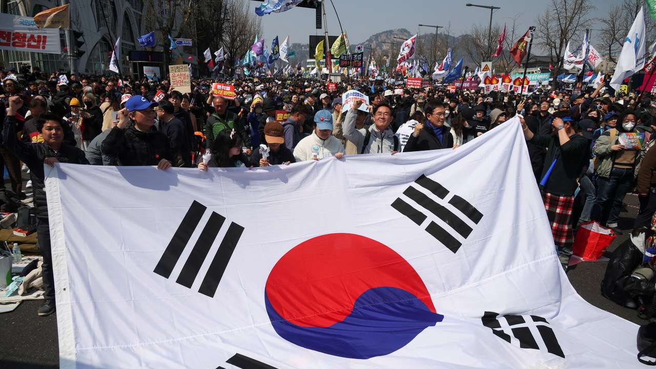 People celebrate after President Yoon Suk Yeol's impeachment was accepted, near the Constitutional Court in Seoul, South Korea