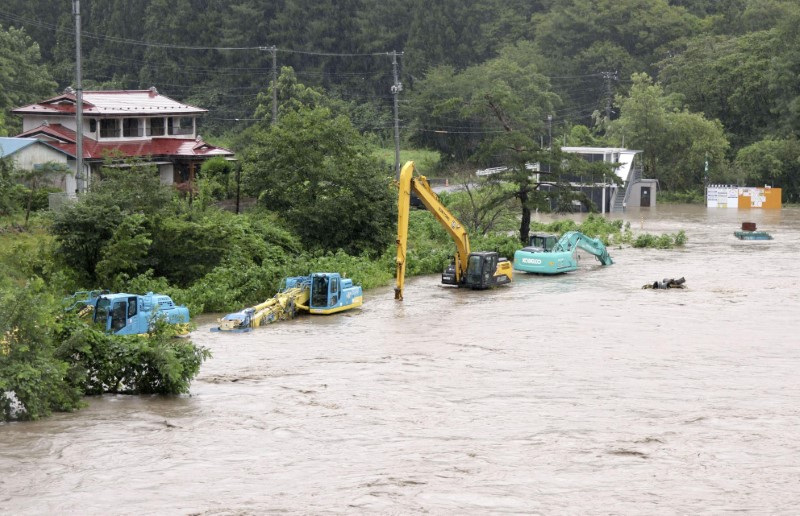 Heavy vehicles are submerged in water after Tropical Storm Maria made landfall, in Iwate prefecture