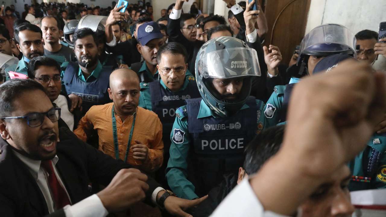 Chinmoy Krishna Das, a Hindu leader associated with the International Society for Krishna Consciousness (ISKCON), is escorted by the police at the Chattogram Metropolitan Magistrate Court, in Chattogram