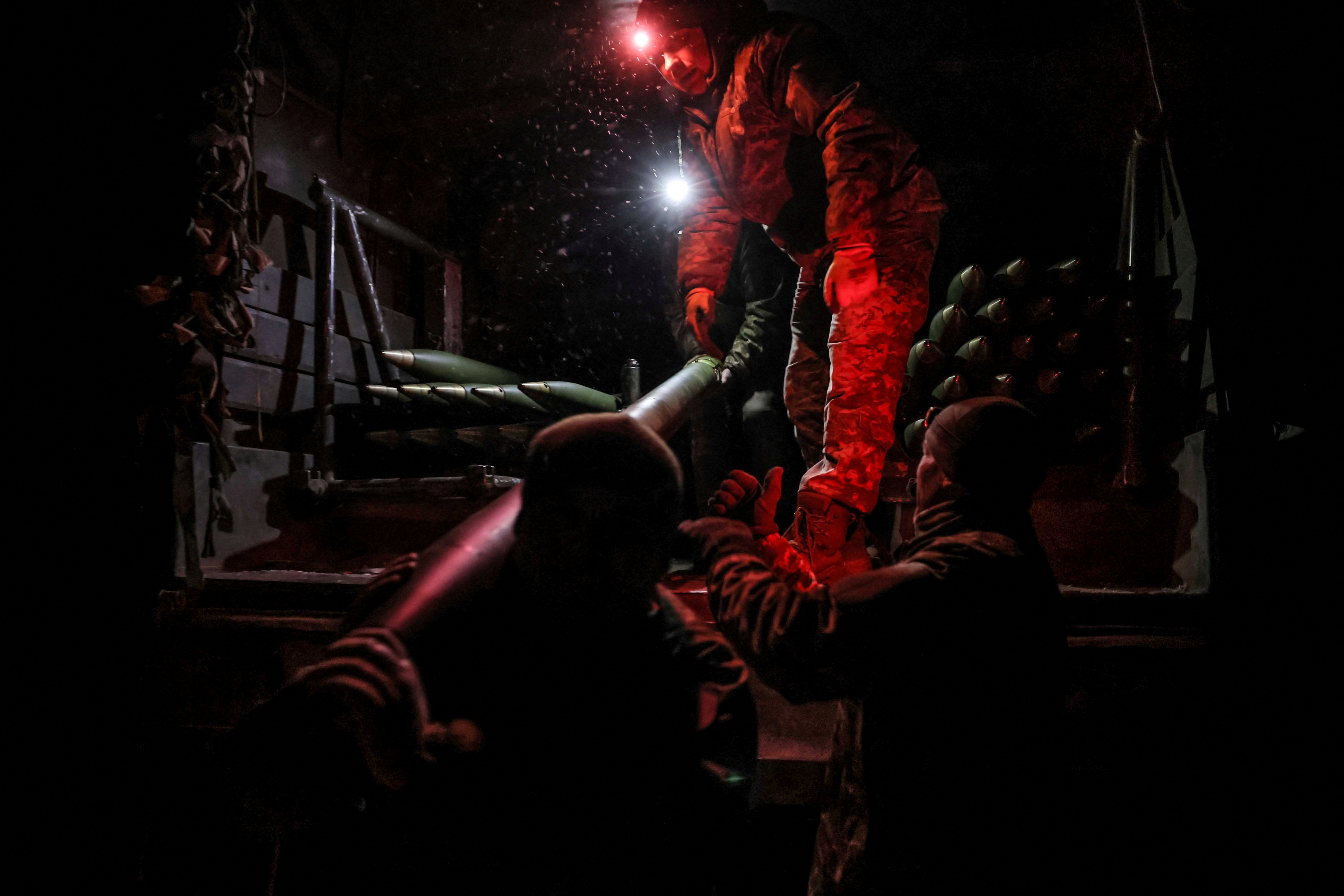 FILE PHOTO: Ukrainian serviceman prepares to fire a BM-21 Grad multiple-launch rocket system toward Russian troops on a front line near the town of Chasiv Yar