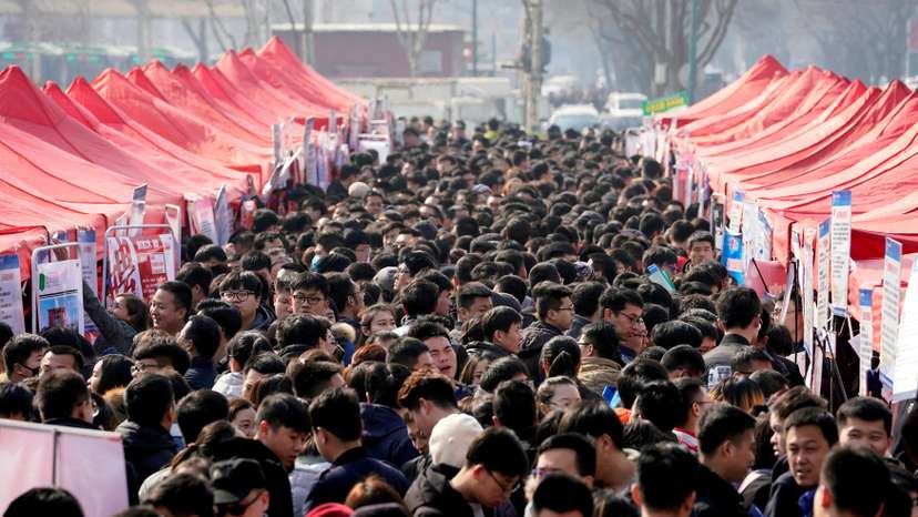 FILE PHOTO: Job seekers crowd a job fair at Liberation Square in Shijiazhuang