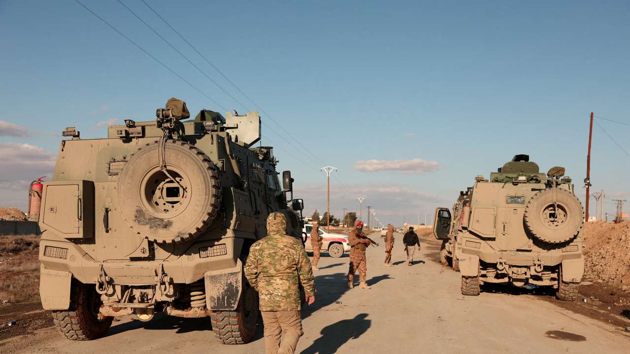 Military members gather near Raqqa prison