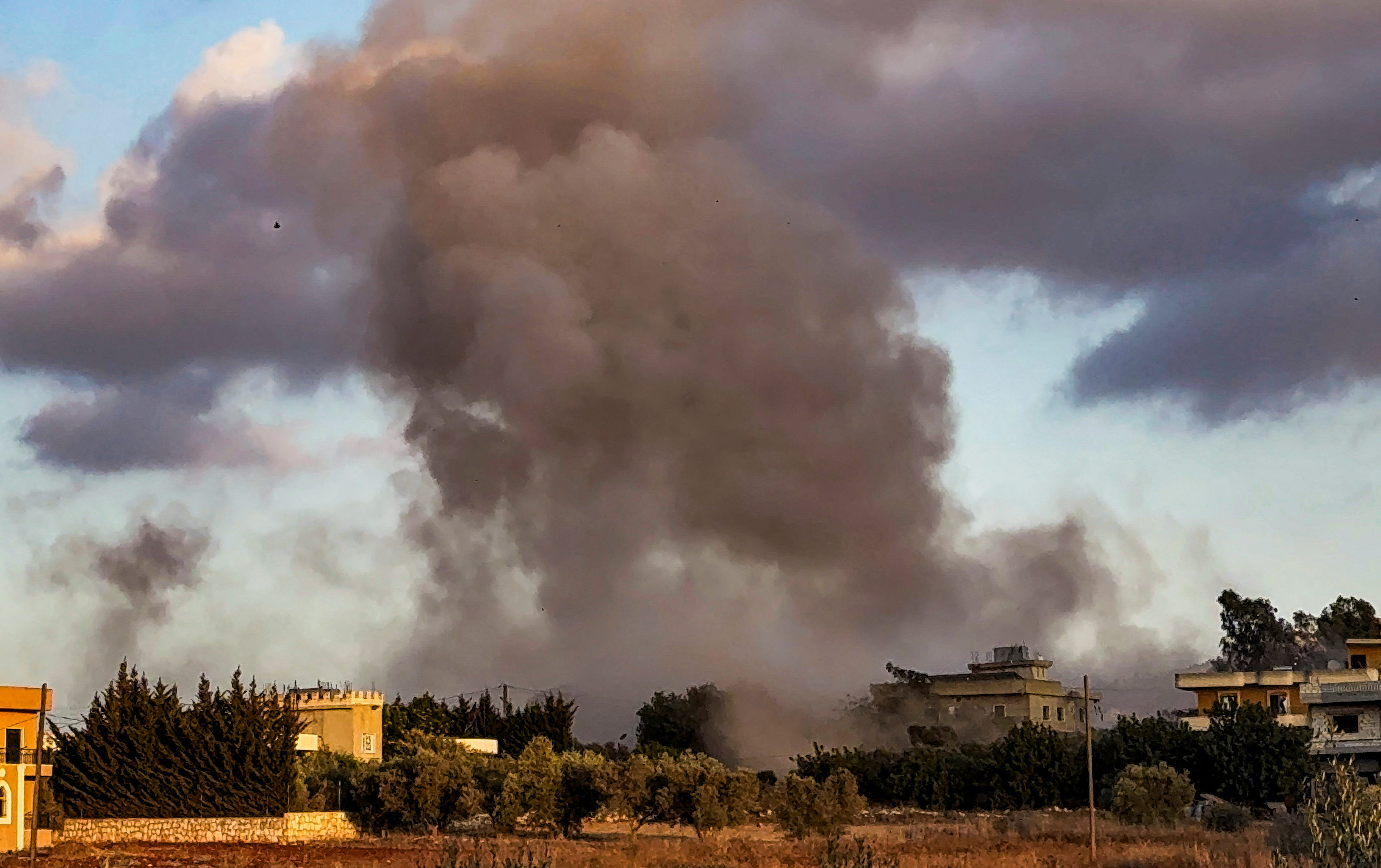 Smoke billows over Kfar Tebnit after an Israeli strike near Lebanon’s border with Israel