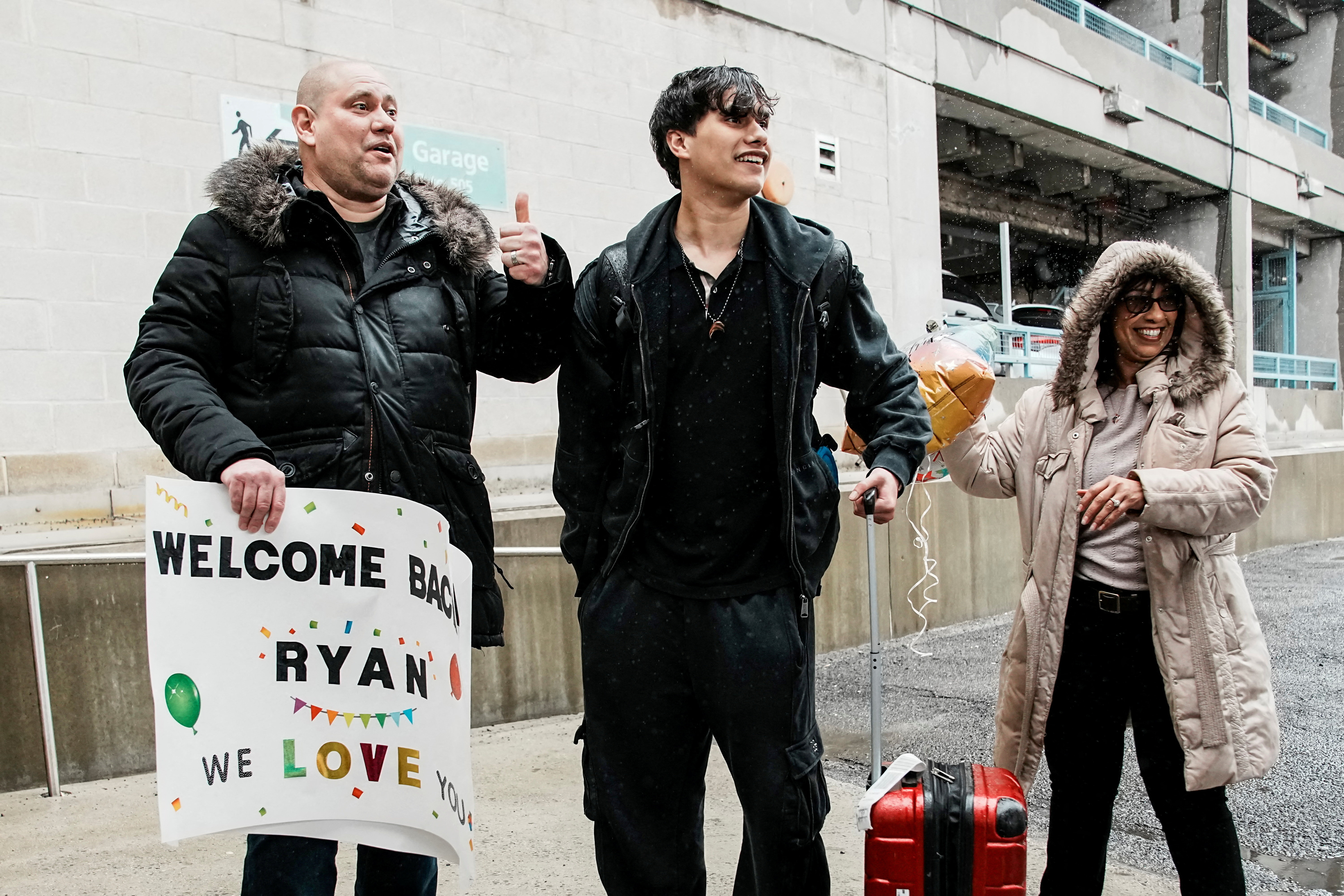 People arrive via U.S. government chartered flight at John F. Kennedy (JFK) International Airport in New York