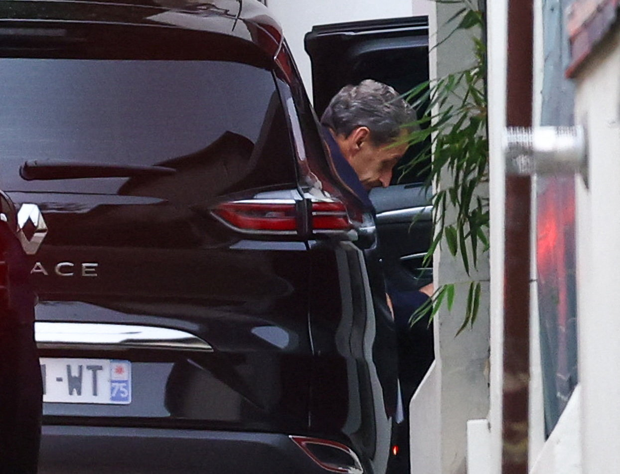 Former French President Sarkozy arrives at his house after being released from jail, in Paris