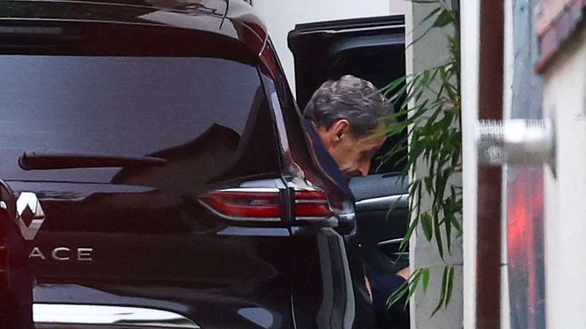 Former French President Sarkozy arrives at his house after being released from jail, in Paris