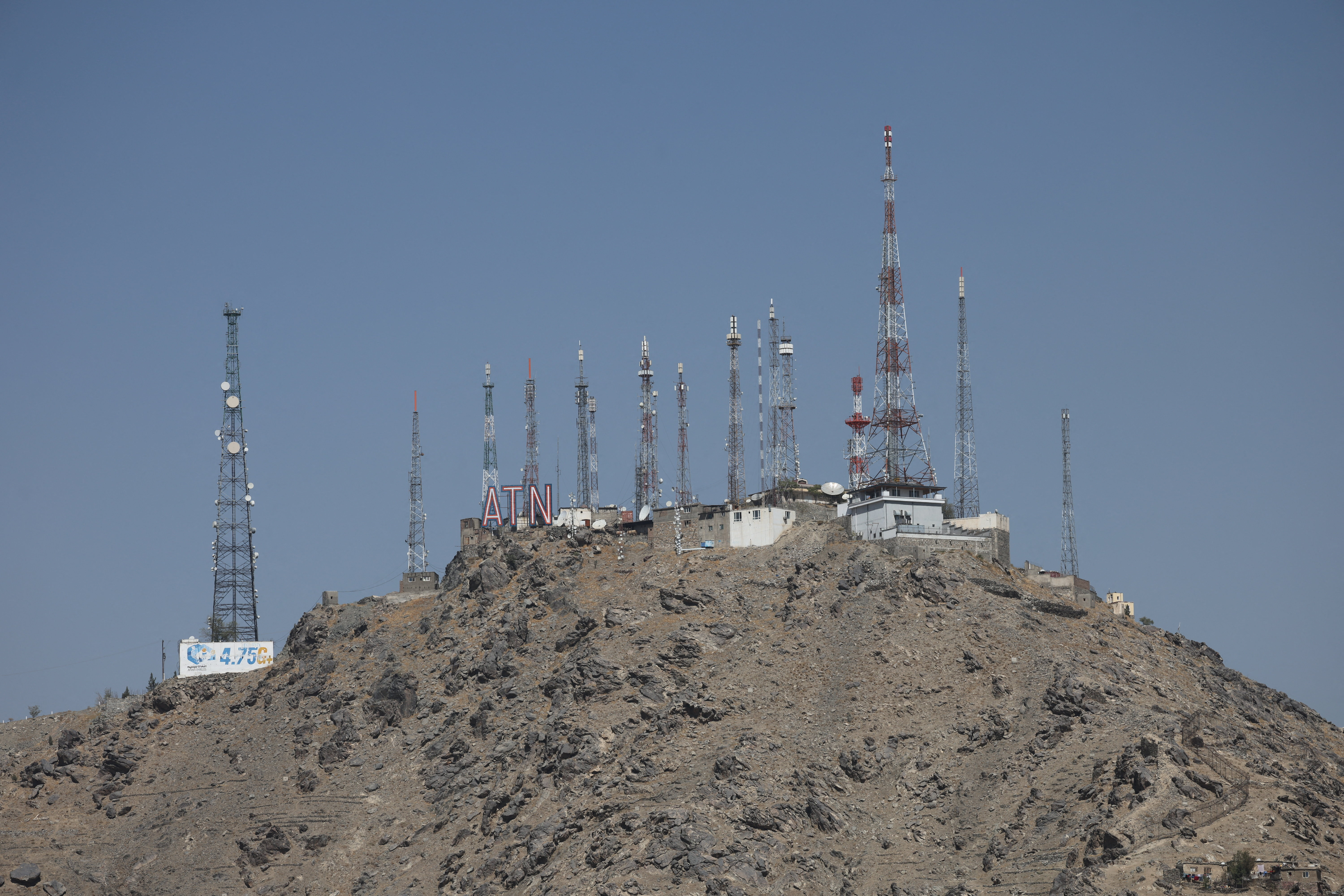Telecom antennas stand on a mountain amid service shutdown across the country, in Kabul