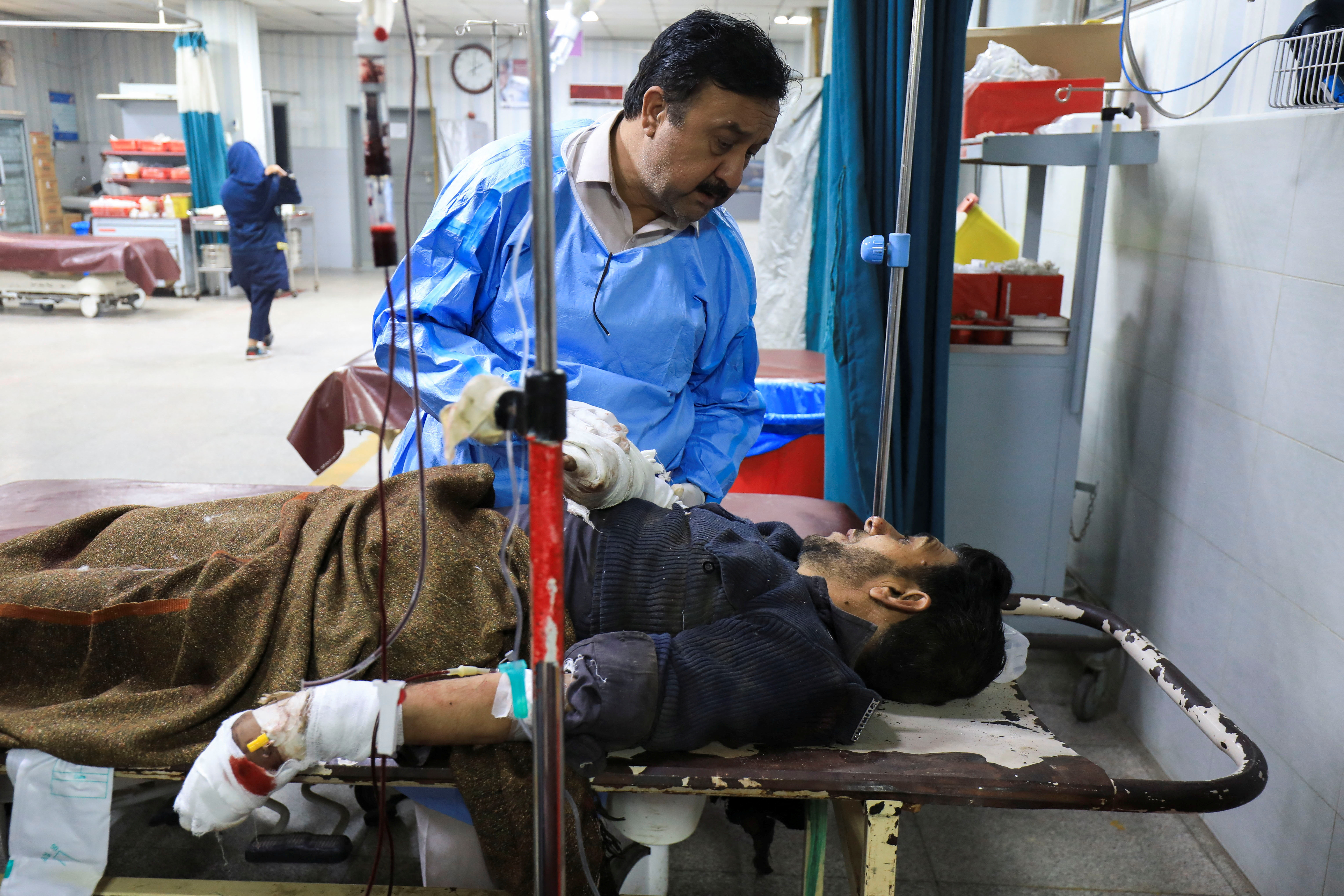 Police officer, who was injured after a bomb blast, receives first aid at hospital in Peshawar
