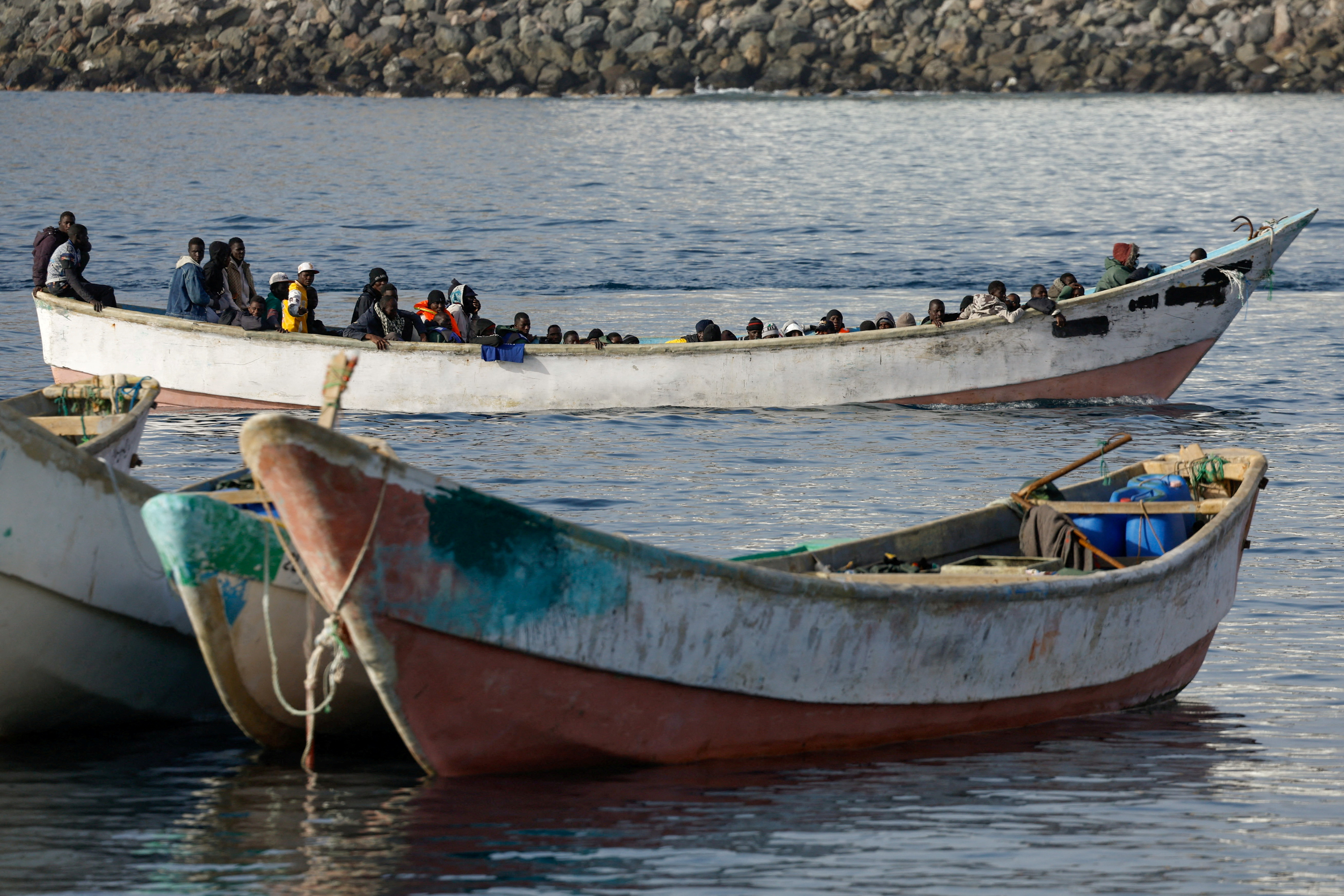 FILE PHOTO: Migrants arrive at the Port of Arguineguin, on the island of Gran Canaria