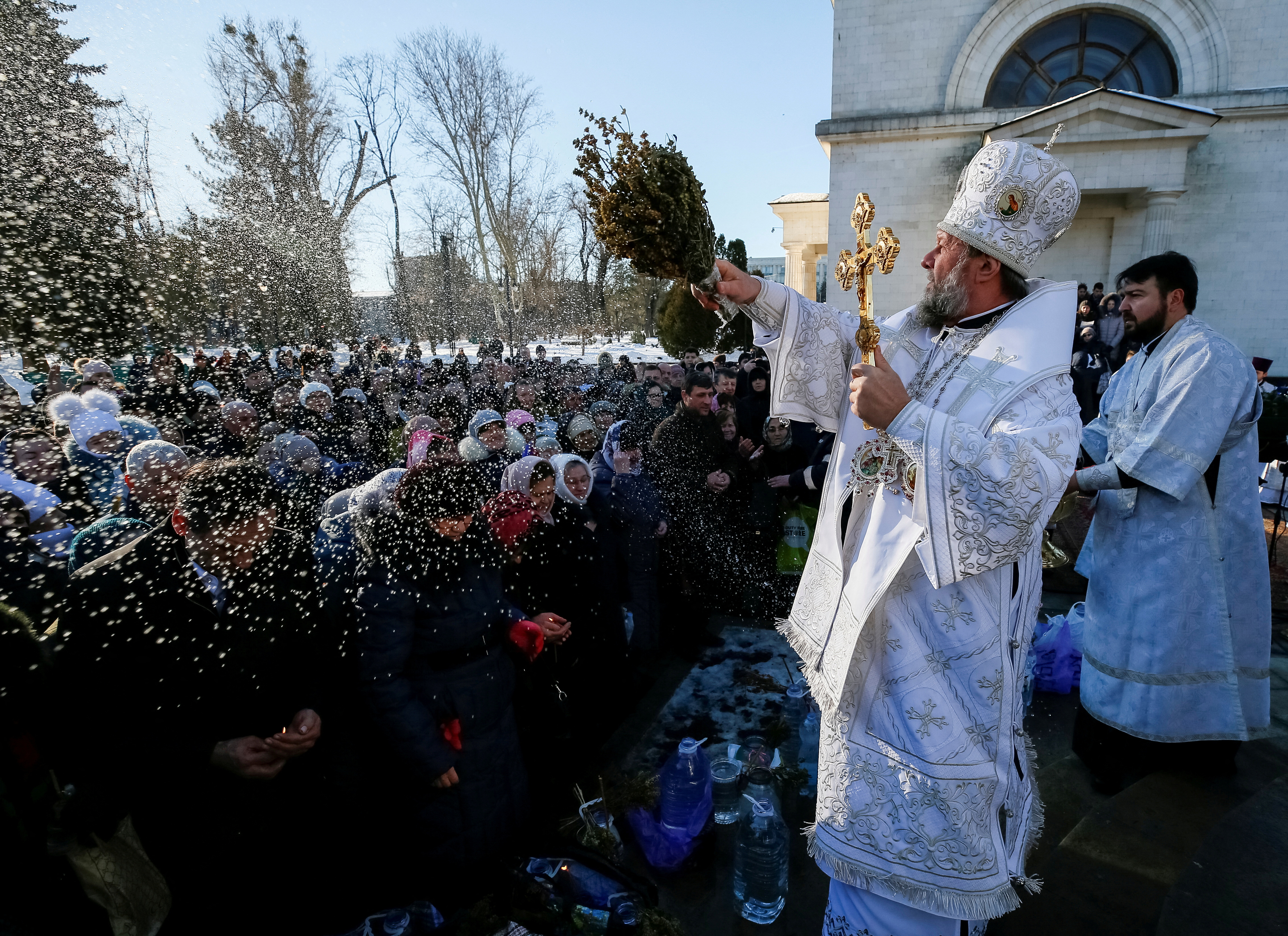 FILE PHOTO: Metropolitan of Chisinau and All Moldova Vladimir splashes water on believers during Orthodox Epiphany celebrations in Chisinau