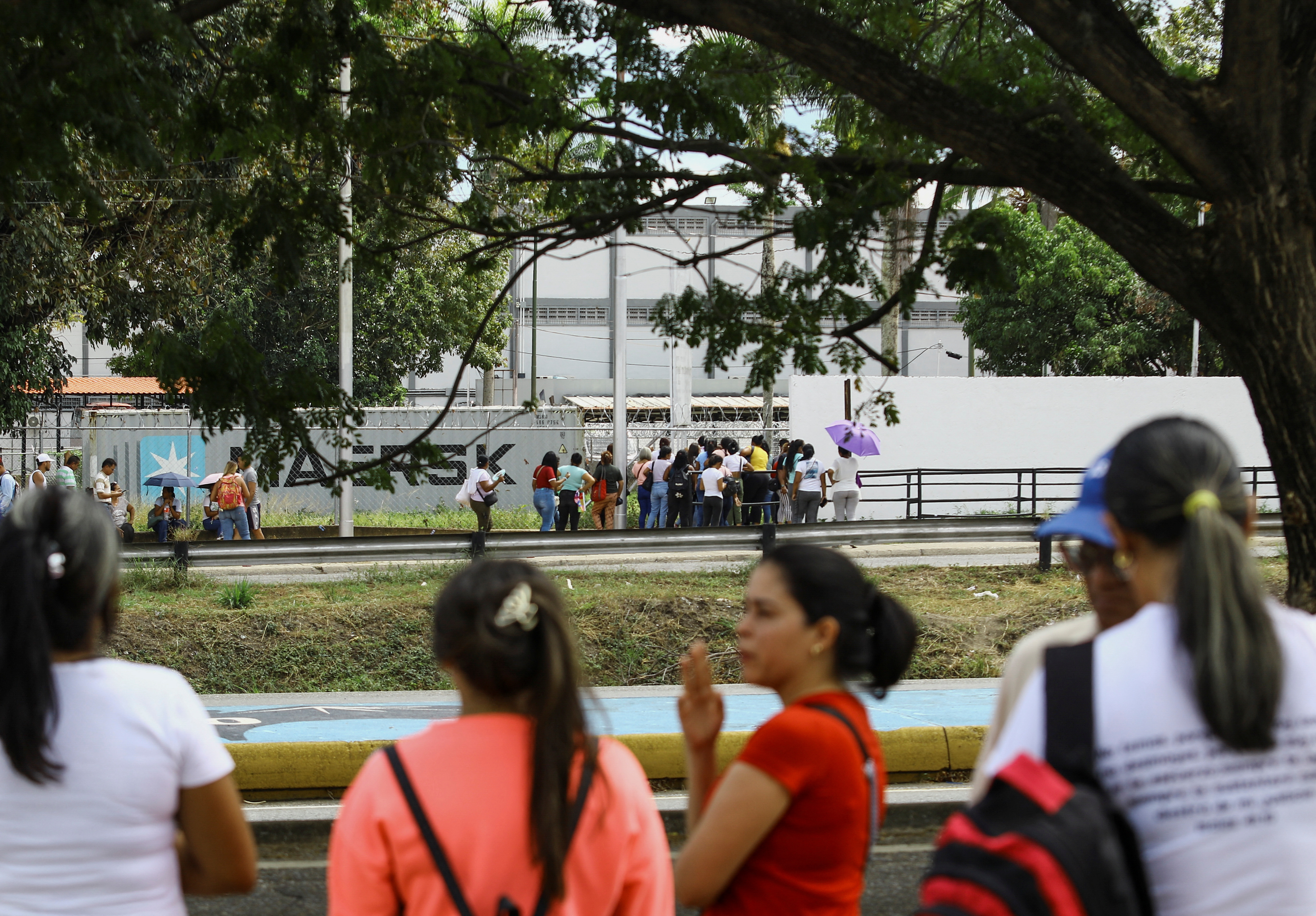 People wait outside the prison for the release of their loved ones detained during protests, in Tocuyito