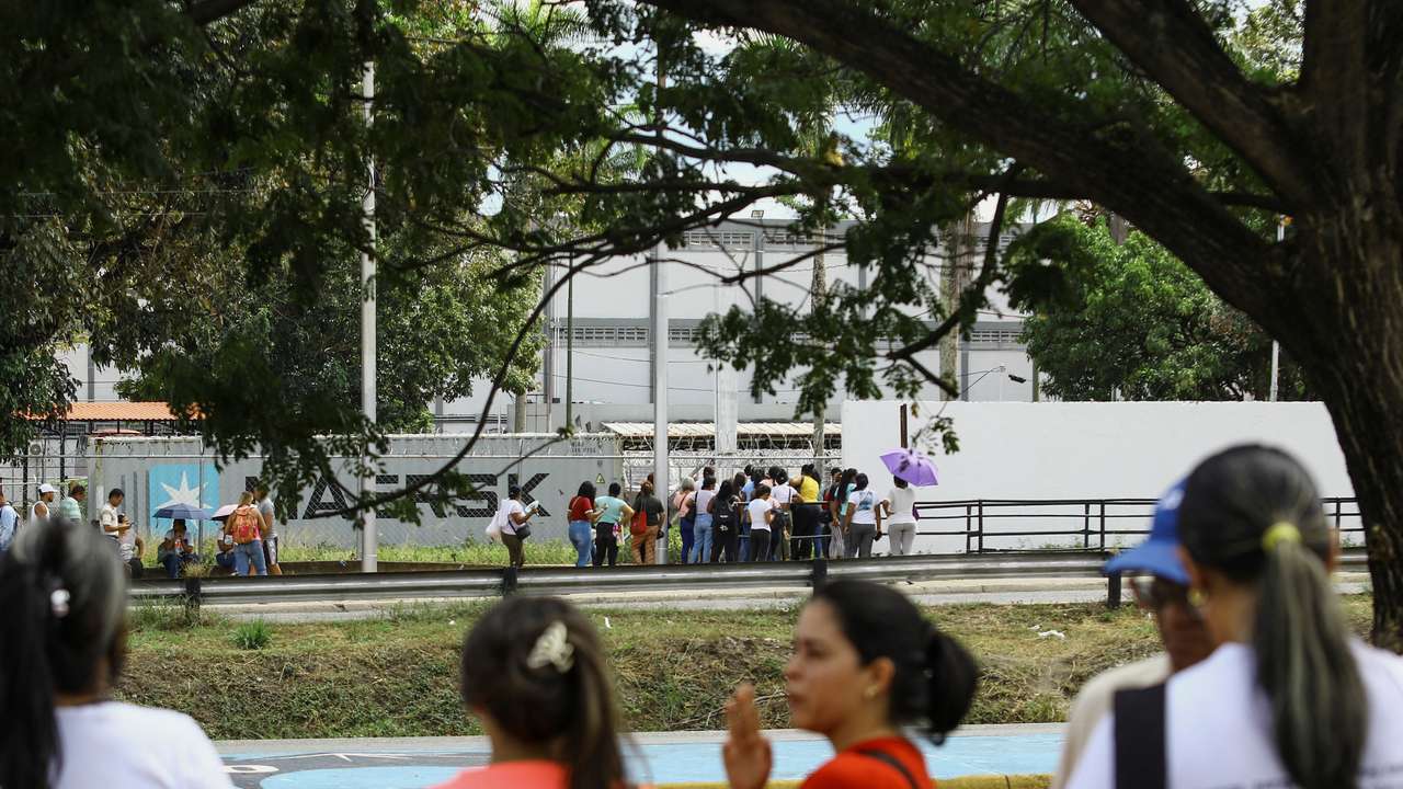 People wait outside the prison for the release of their loved ones detained during protests, in Tocuyito