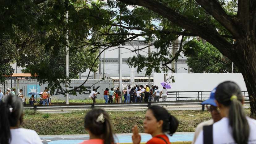 People wait outside the prison for the release of their loved ones detained during protests, in Tocuyito