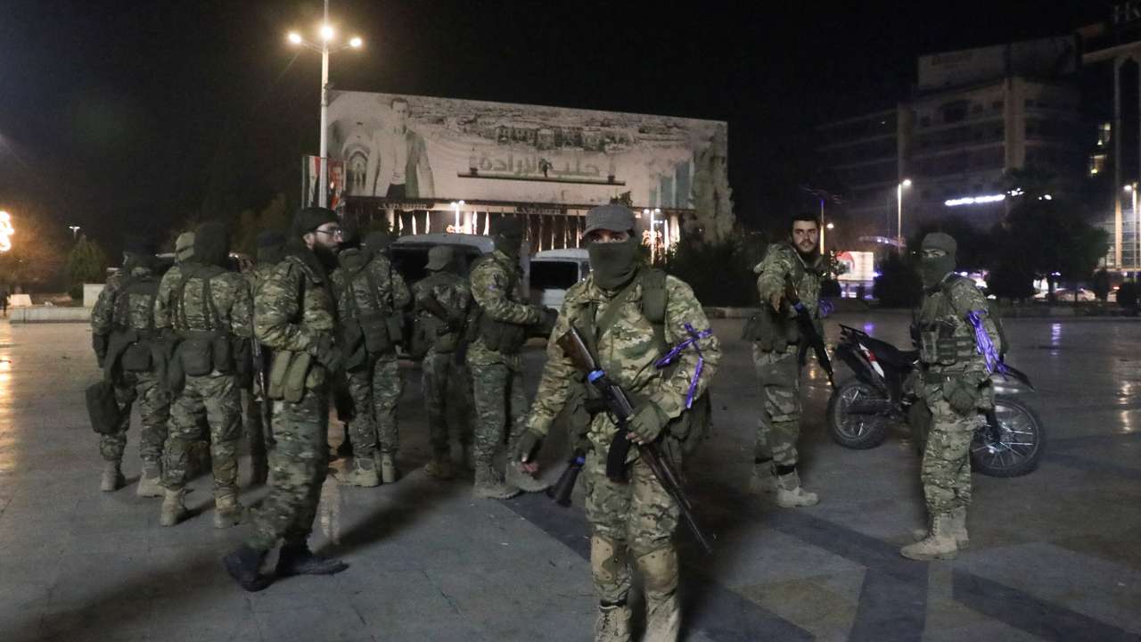 Syrian opposition fighters gather at Saadallah al-Jabiri Square, after rebels opposed to President Bashar al-Assad said they had reached the heart of Aleppo