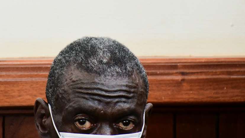 Uganda's four-time presidential candidate Kizza Besigye sits in the dock where he was charged with treason at the Chief Magistrate Court in Nakawa suburb of Kampala