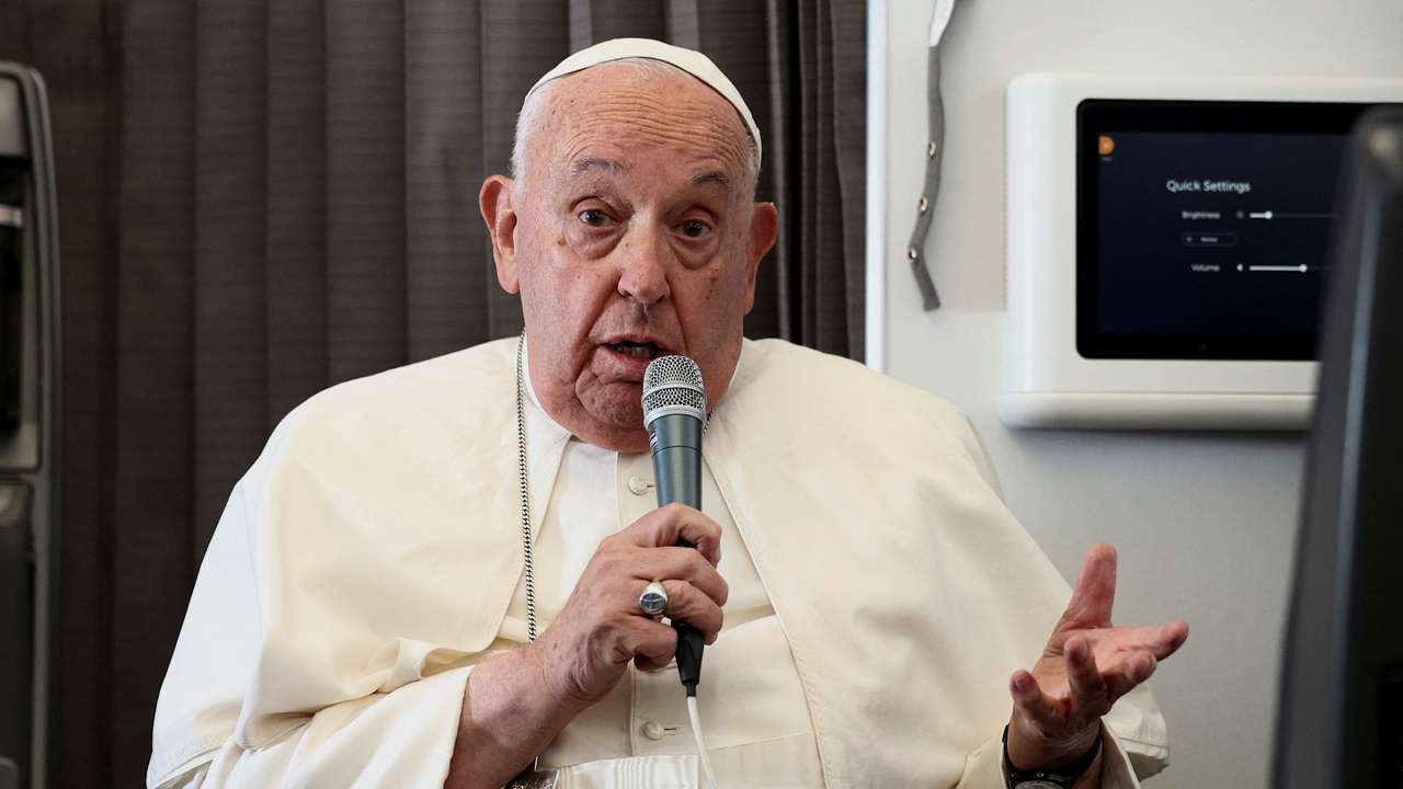 Pope Francis holds a news conference aboard the papal plane